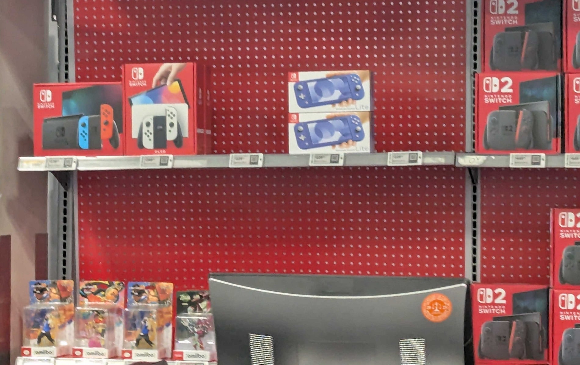 Switch consoles sit on a shelf at Best Buy. 